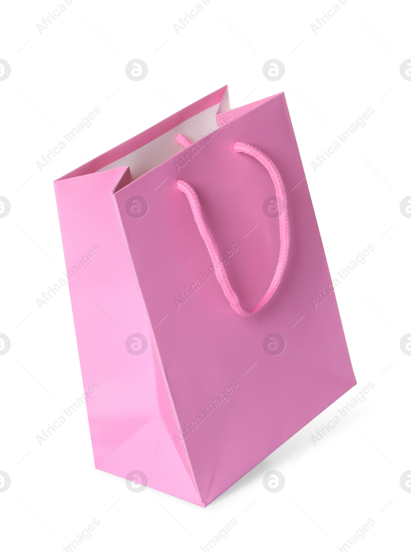 Photo of One pink shopping bag isolated on white