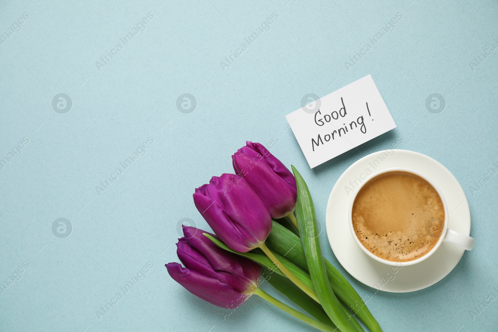 Photo of Delicious coffee, flowers and card with GOOD MORNING wish on light background, flat lay. Space for text