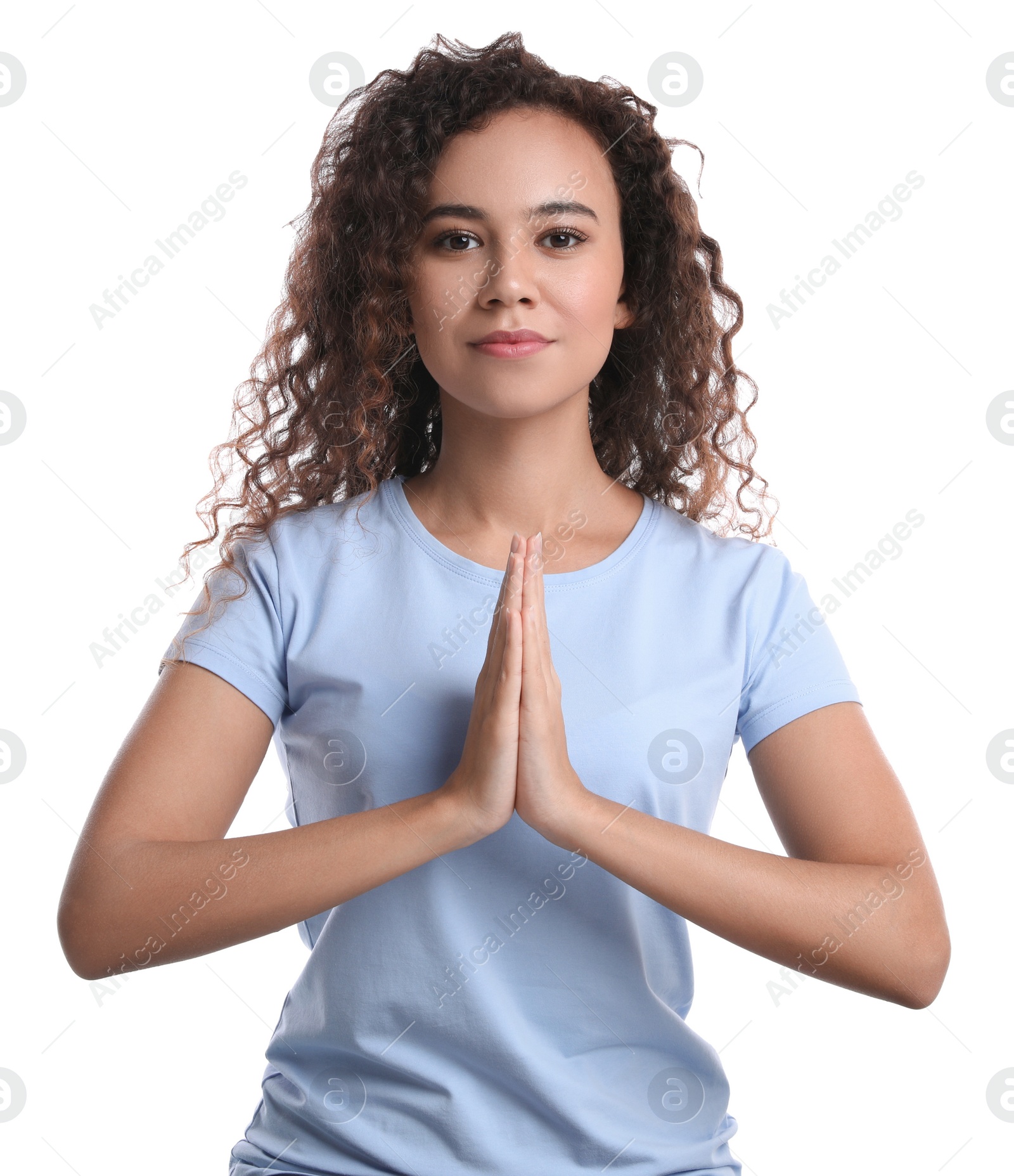 Photo of Beautiful African-American woman meditating on white background