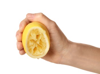 Woman squeezing lemon half on white background, closeup