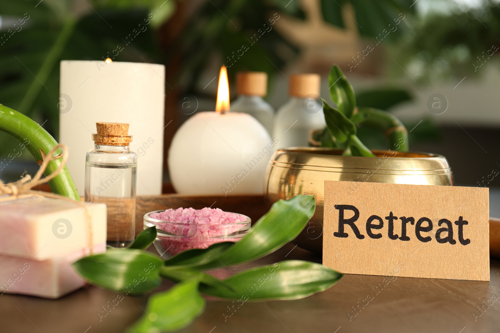 Photo of Retreat concept. Composition with card, singing bowl and different spa products on grey table