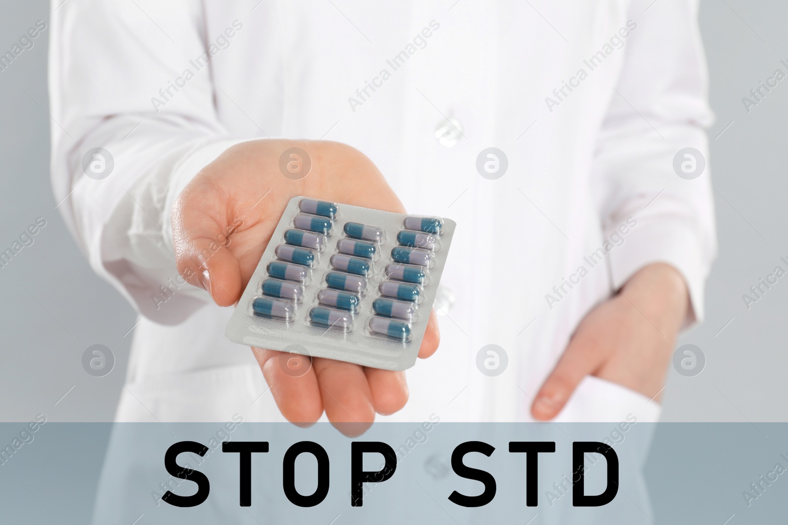 Image of STOP STD. Doctor with pills on light grey background, closeup