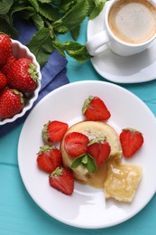 Photo of Tasty vanilla fondant with white chocolate, strawberries and cup of coffee on light blue wooden table, flat lay