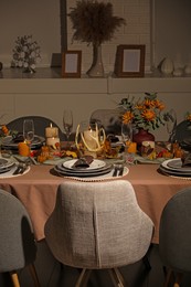Photo of Table set with beautiful autumn decor for festive dinner in room