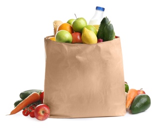 Photo of Paper bag with different groceries on white background