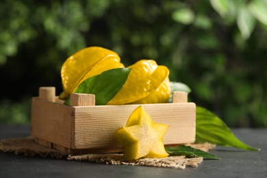 Delicious carambola fruits and slice on black table