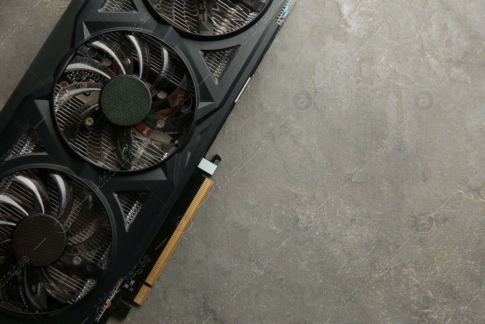 Photo of One graphics card on grey table, top view. Space for text