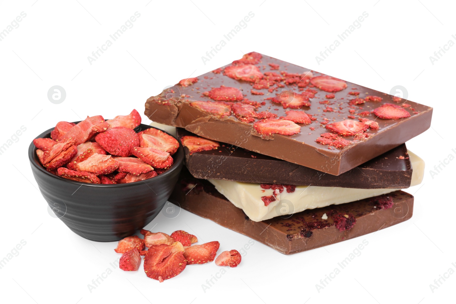 Photo of Chocolate bars with freeze dried strawberries on white background