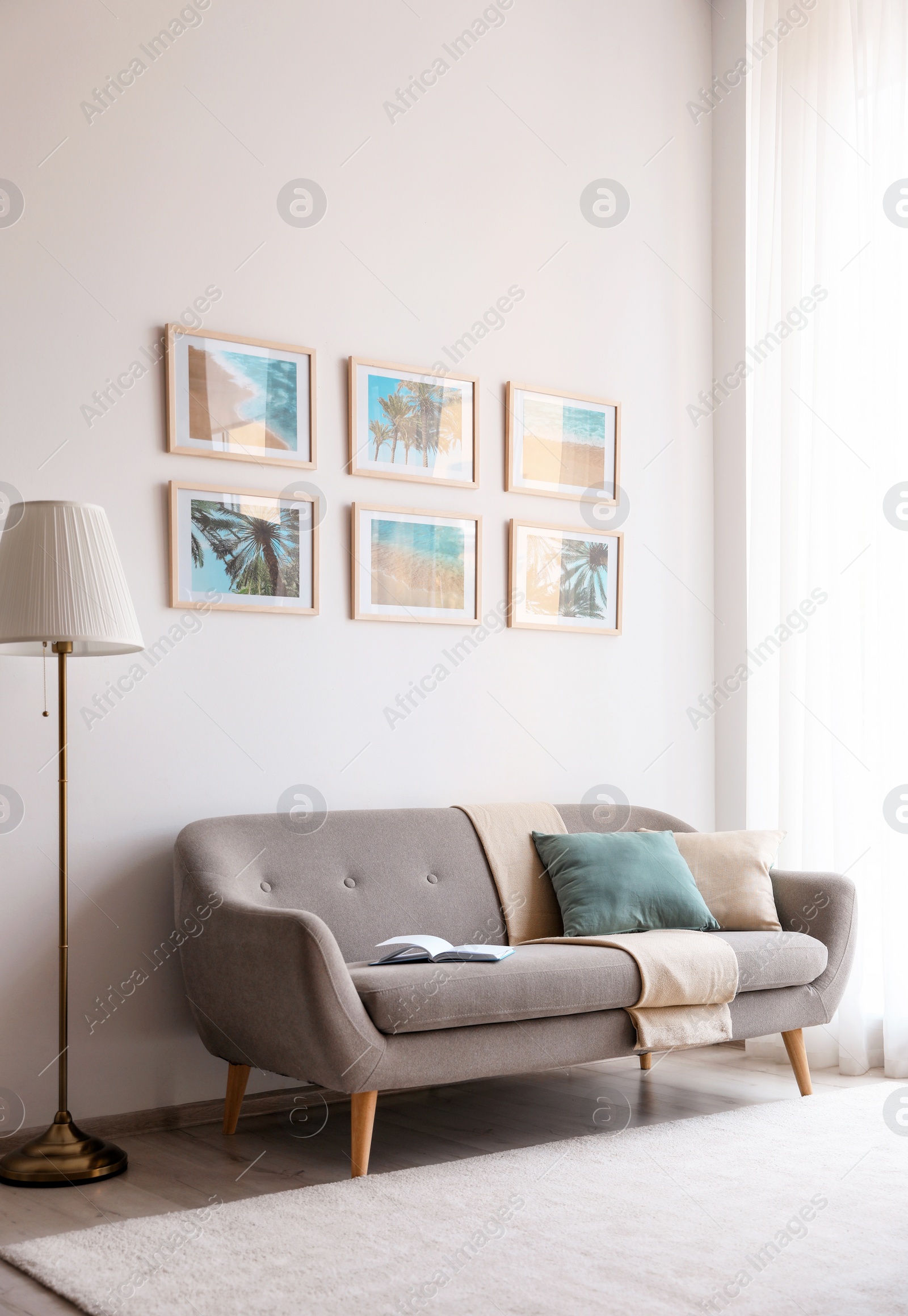 Photo of Stylish room interior with trendy furniture and pictures on wall