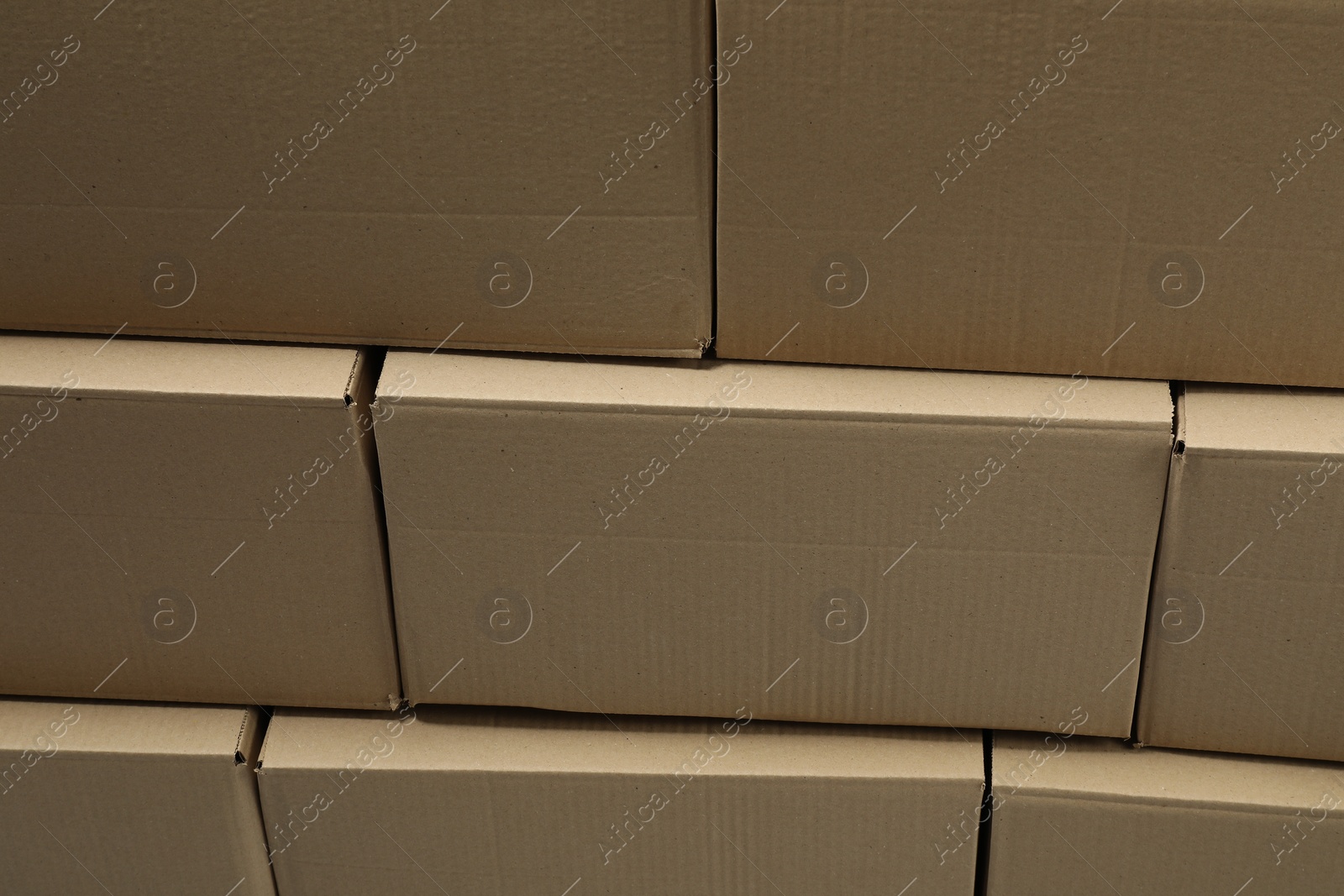 Photo of Stack of many closed cardboard boxes as background