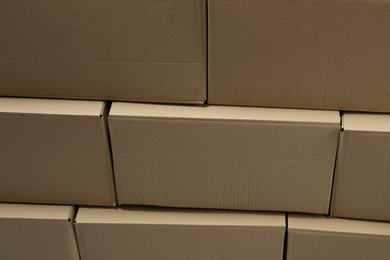 Stack of many closed cardboard boxes as background