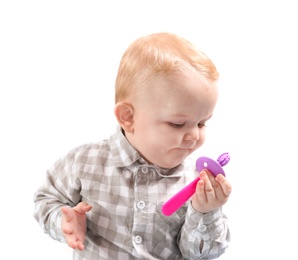 Photo of Little boy with toothbrush on white background. Baby accessories