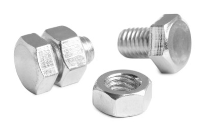 Photo of Metal bolts with hex nuts on white background
