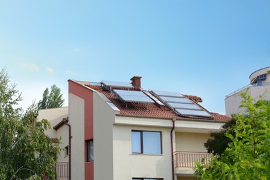 Photo of Beautiful house with solar panels on roof outdoors