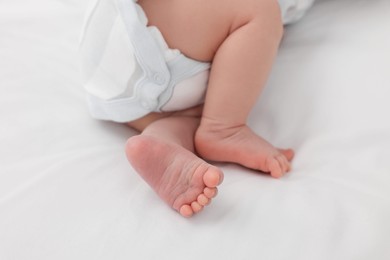 Photo of Newborn baby lying on white blanket, closeup