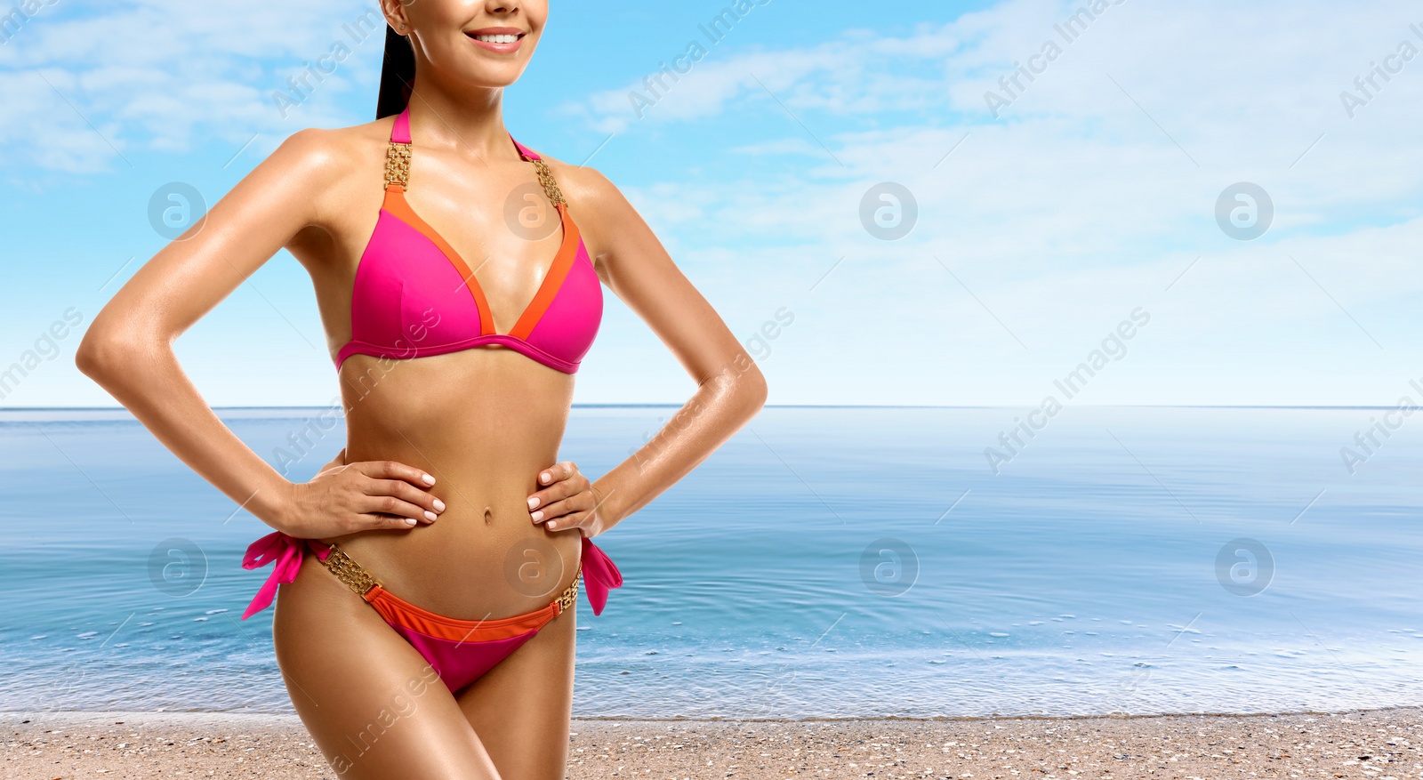 Image of Young woman with sexy body on sandy beach, closeup. Space for text