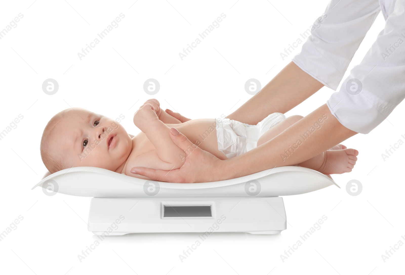 Photo of Doctor weighting baby on scales against white background