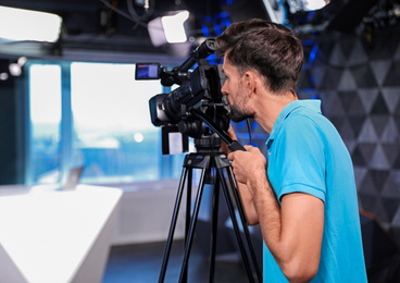 Photo of Professional video camera operator working in studio