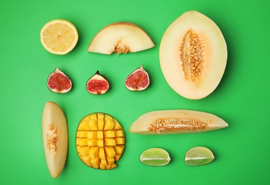 Flat lay composition with melon and other fruits on color background