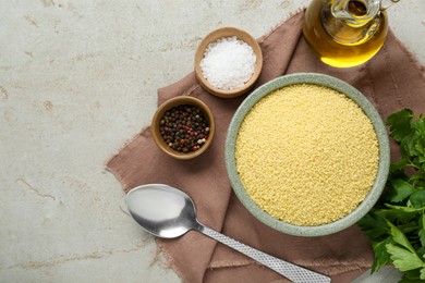 Photo of Raw couscous and ingredients on light table, flat lay. Space for text