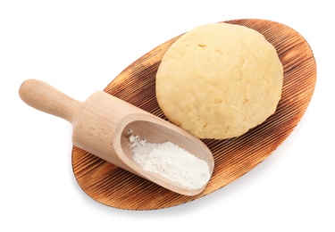 Photo of Wooden board with raw dough and scoop on white background, top view