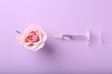 Photo of Cosmetology. Medical syringe and rose flower on violet background, flat lay