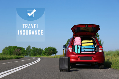 Suitcase near family car with open trunk full of luggage on highway. Travel insurance
