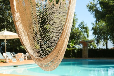 Hammock near pool with clean water outdoors, closeup