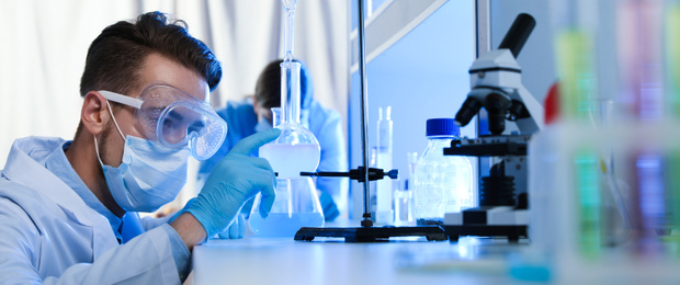 Image of Young scientist doing research and analysis in chemical laboratory. Banner design  