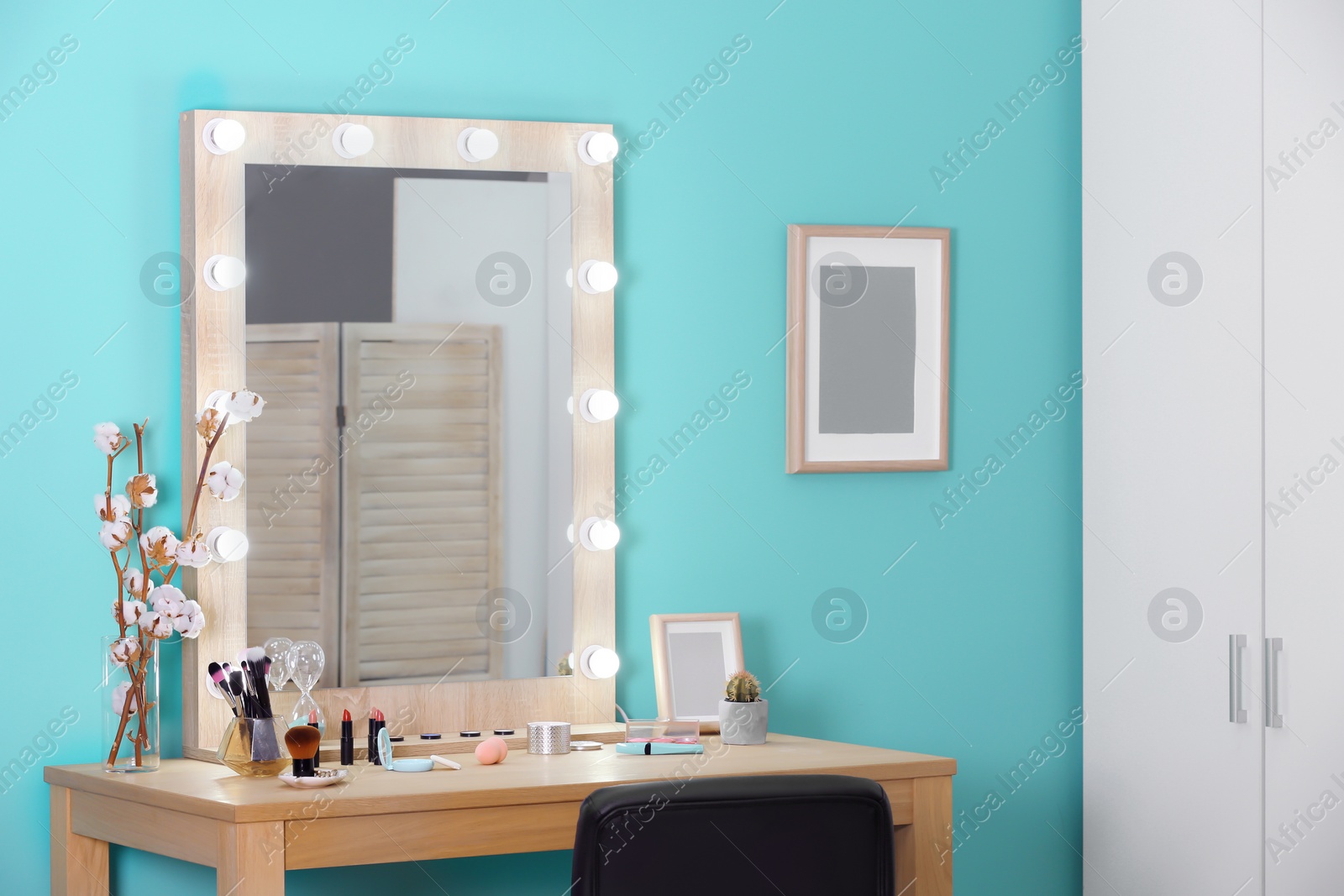 Photo of Decorative cosmetics and tools on dressing table near mirror in makeup room