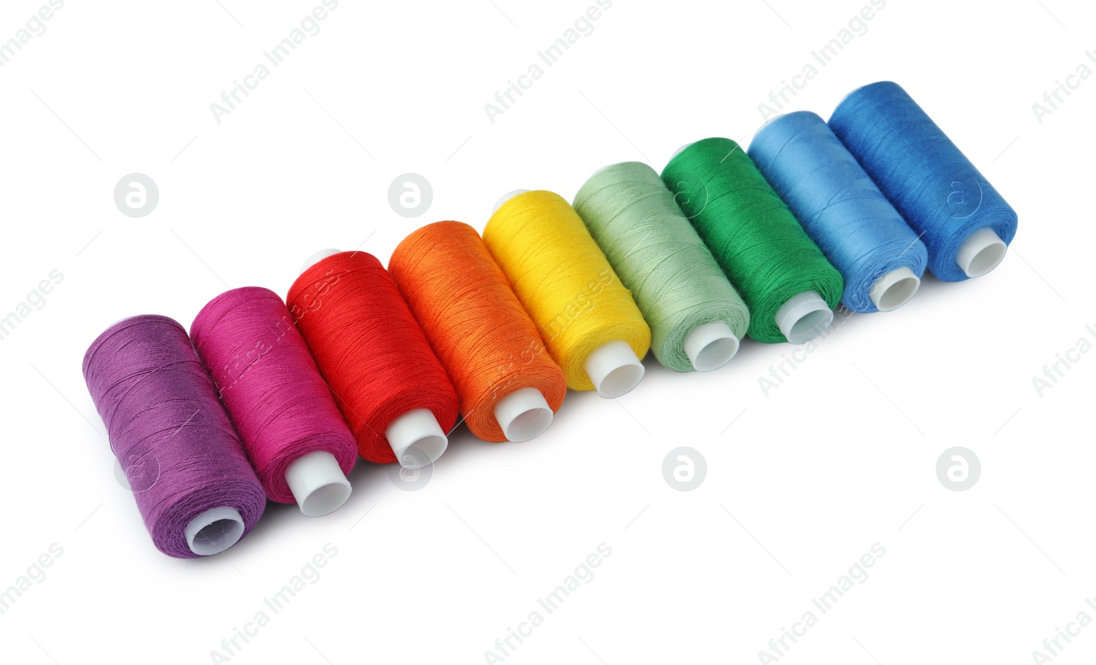 Photo of Set of different colorful sewing threads on white background