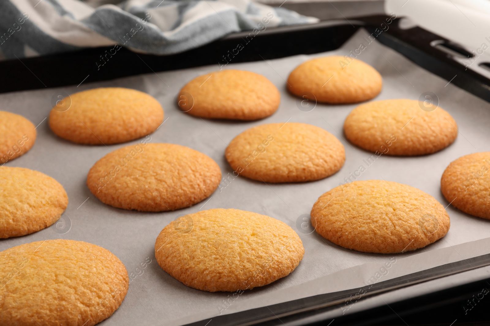 Photo of Delicious Danish butter cookies on baking tray, closeup