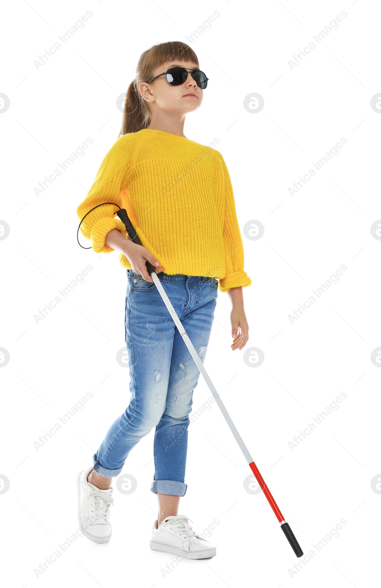 Photo of Blind girl with long cane walking on white background