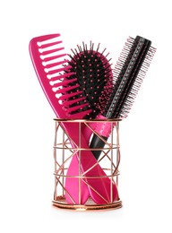 Photo of Hairbrushes and comb in holder on white background