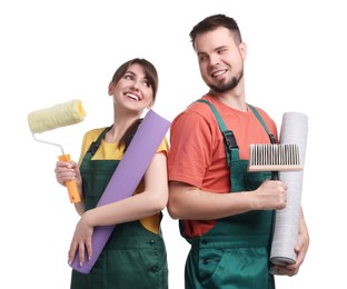 Photo of Workers with wallpaper rolls, roller and brush on white background