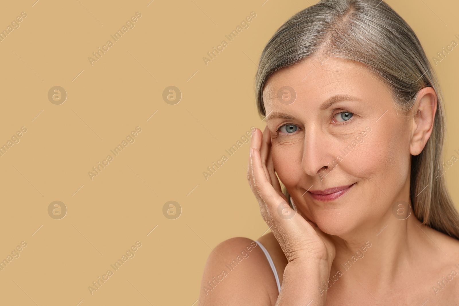 Photo of Portrait of senior woman with aging skin on beige background, space for text. Rejuvenation treatment