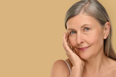Photo of Portrait of senior woman with aging skin on beige background, space for text. Rejuvenation treatment