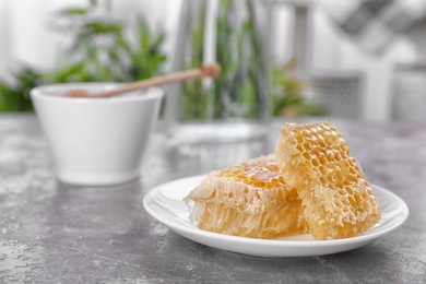 Photo of Plate with honeycombs on table, closeup
