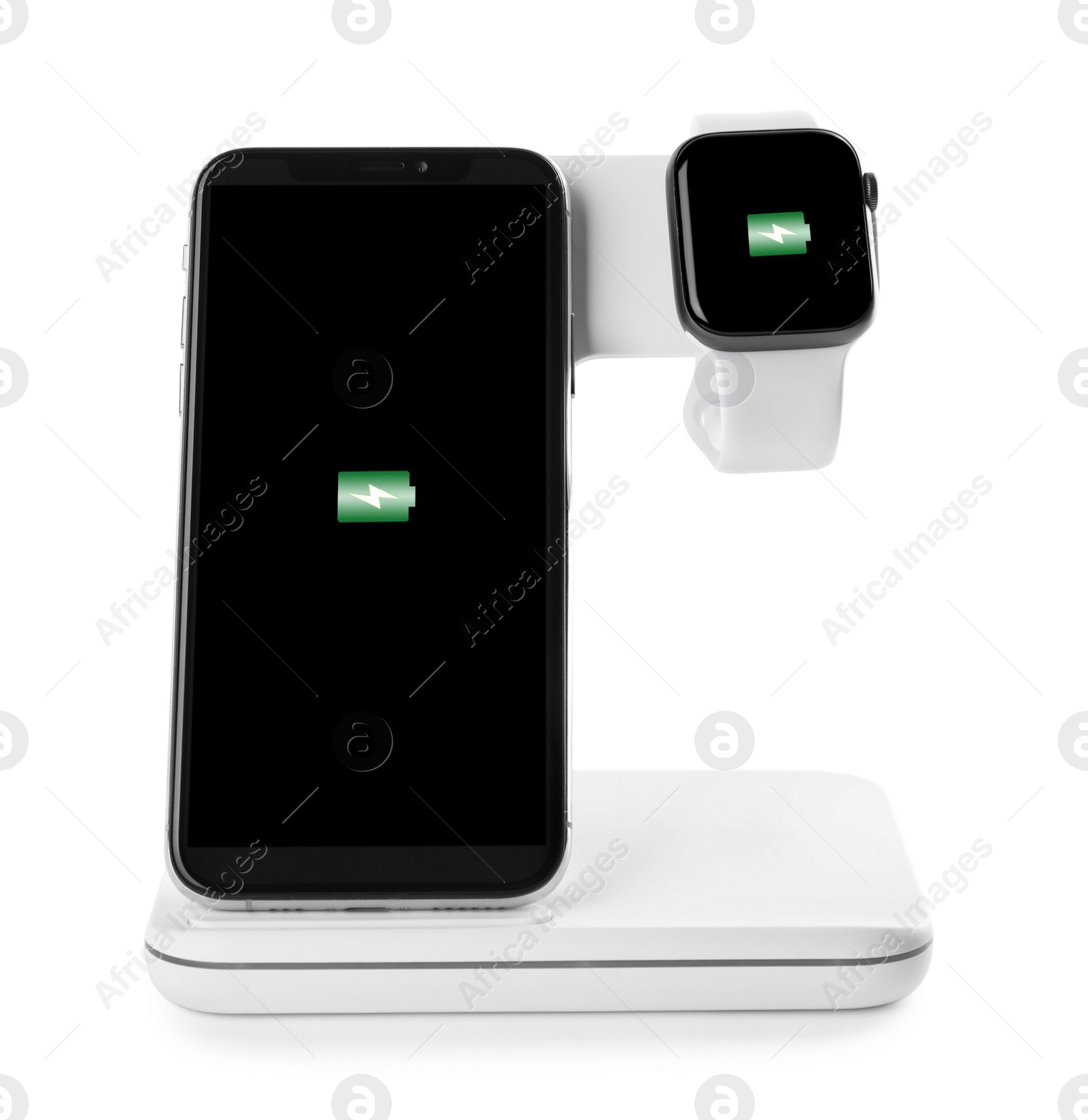 Photo of Mobile phone and smartwatch charging with wireless pad isolated on white