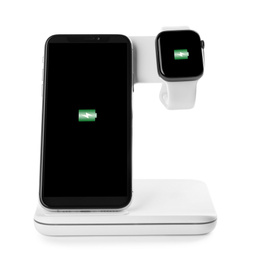 Photo of Mobile phone and smartwatch charging with wireless pad isolated on white