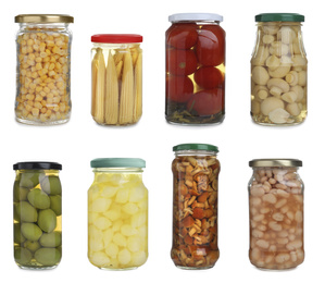 Image of Set of different jars with pickled vegetables and mushrooms on white background 