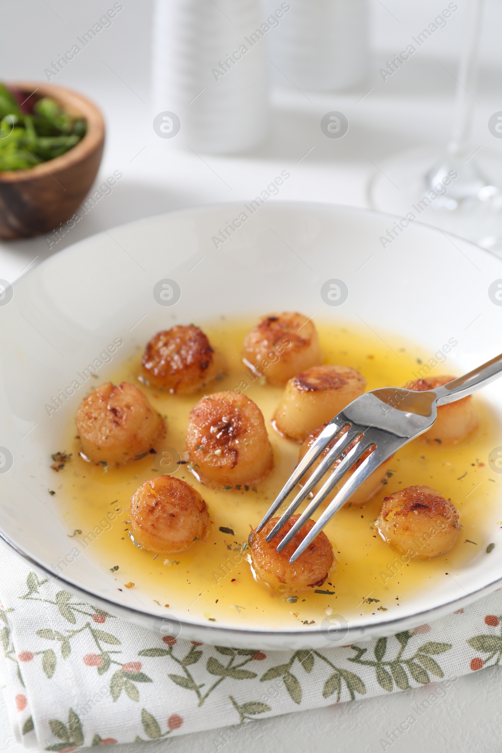 Photo of Delicious fried scallops served on white table