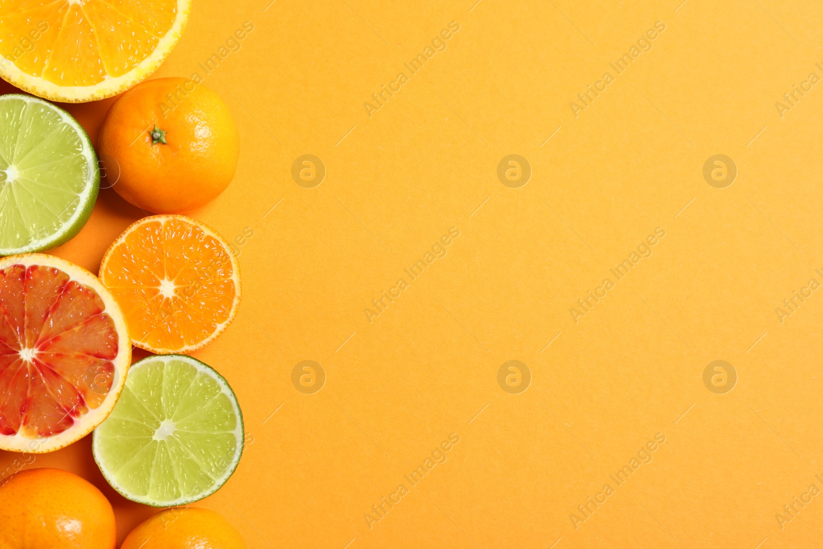 Photo of Different citrus fruits on color background, flat lay. Space for text