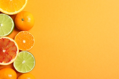 Different citrus fruits on color background, flat lay. Space for text