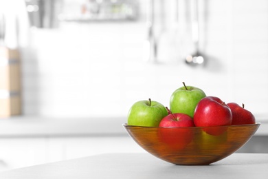 Photo of Bowl of fresh apples on kitchen counter. Space for text