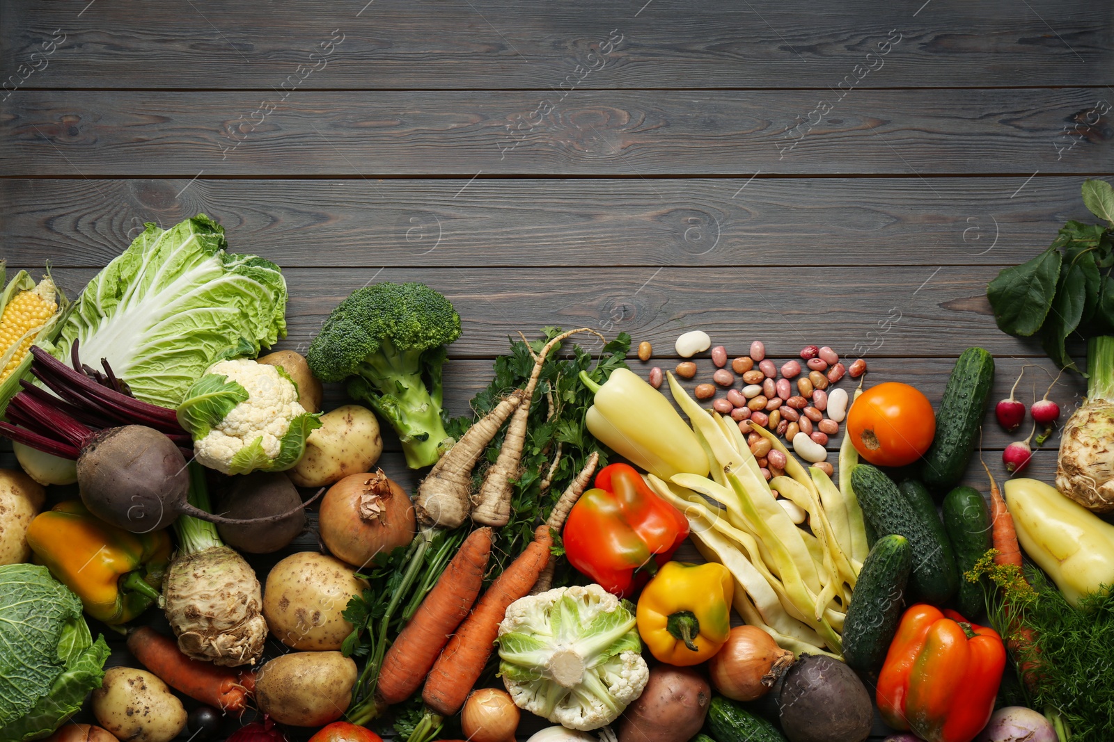 Photo of Different fresh vegetables on wooden table, flat lay with space for text. Farmer harvesting