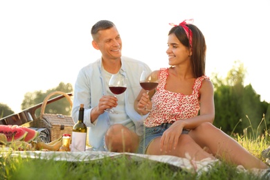 Photo of Happy couple having picnic in park on sunny day