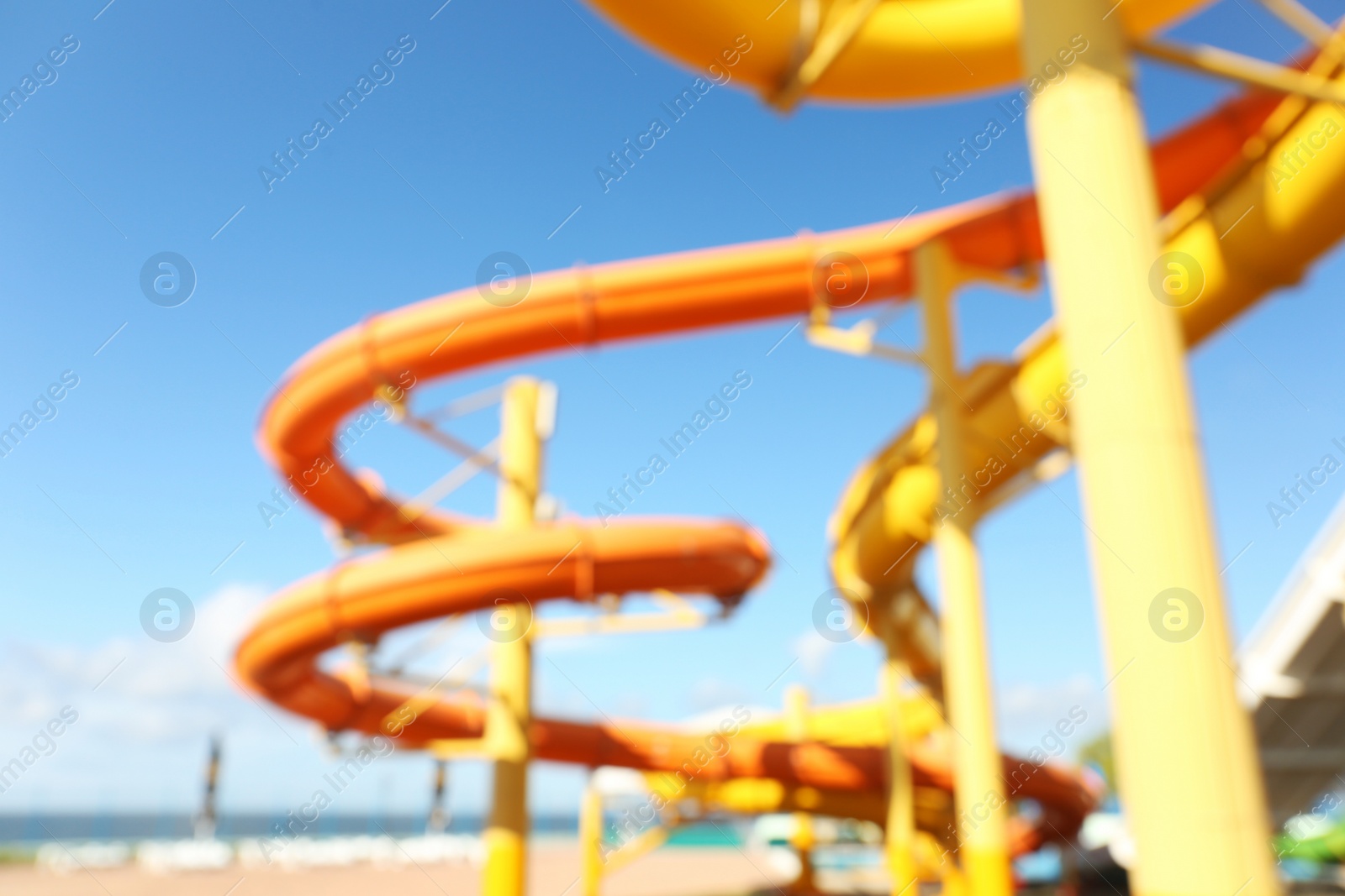 Photo of Different colorful slides in water park, blurred view