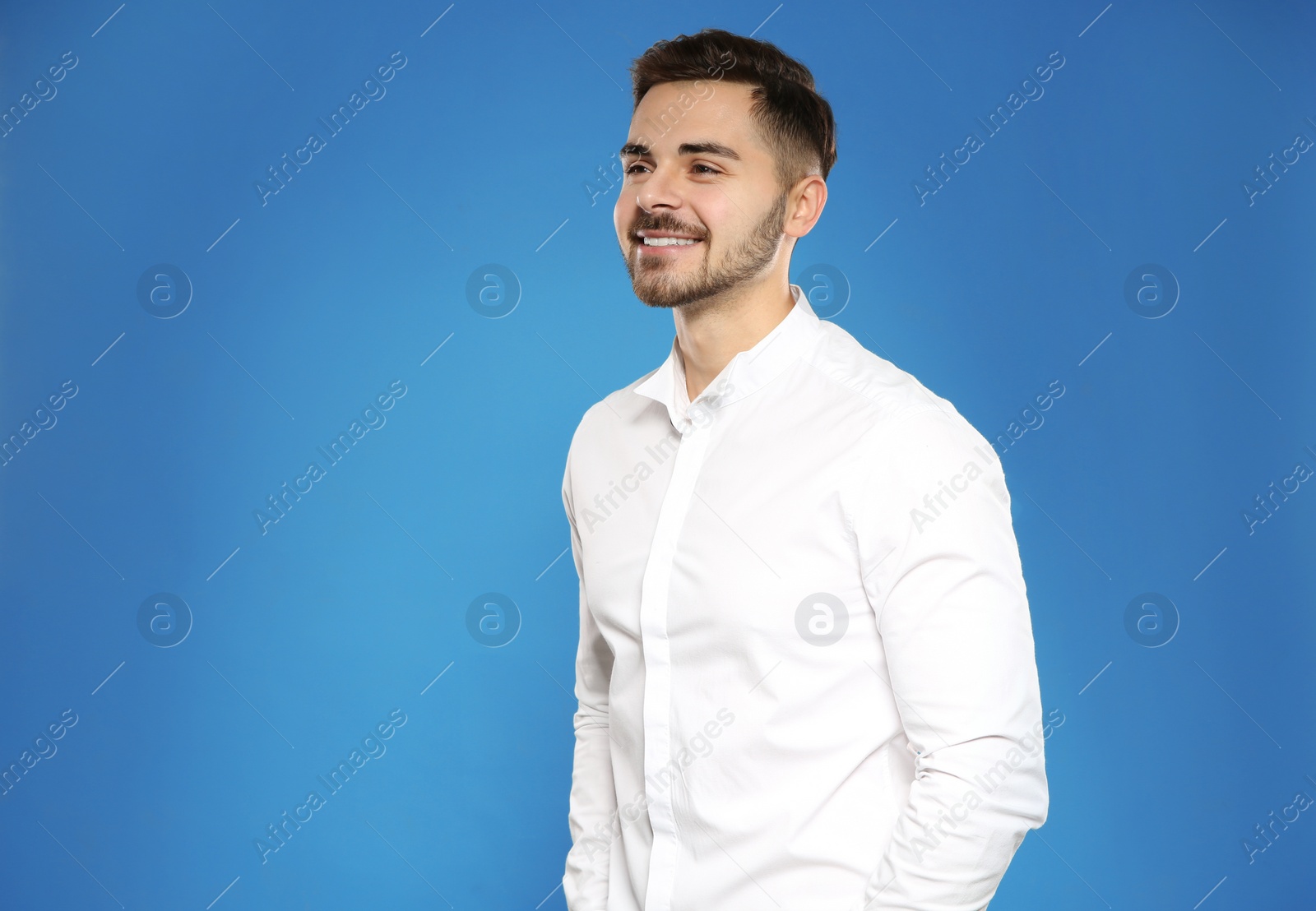 Photo of Portrait of handsome young man on color background