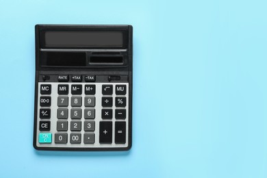 Photo of Modern calculator on turquoise background, top view. Space for text